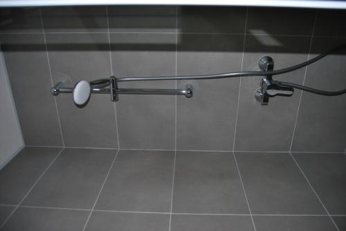 a shower stall with a shower head on a wall at Estudiotel Alicante in Alicante