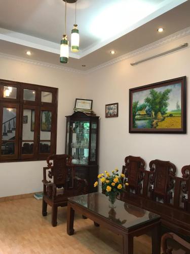 a living room with a table and chairs at 105 Láng Hạ in Hanoi