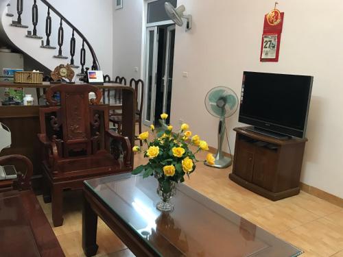 a living room with a vase of flowers on a table at 105 Láng Hạ in Hanoi