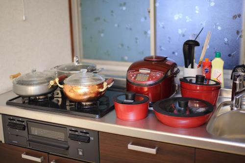 a kitchen counter with pots and pans on a stove at Fuji Time Traveler in Fujikawaguchiko