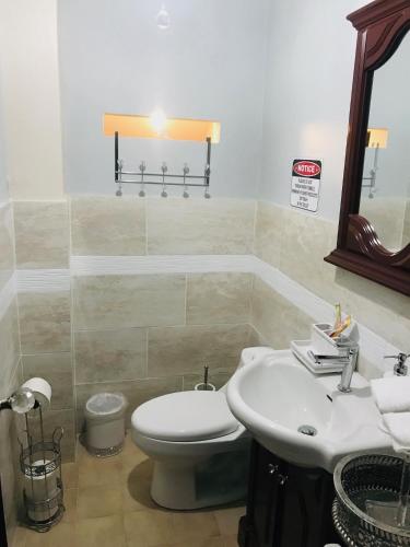 a bathroom with a white toilet and a sink at The Balconies Studio, The Marilyn Suite & The Crystal Apartment at Casa of Essence in Old San Juan in San Juan