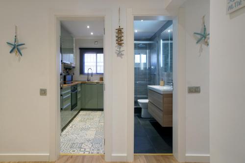 a bathroom with a shower and a sink and a toilet at Beach Club House in Castelldefels