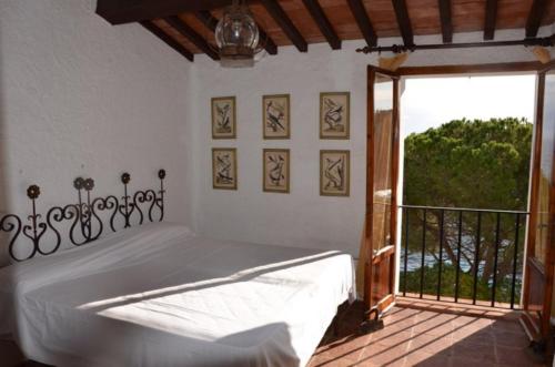 a bedroom with a bed and a large window at Ammiraglio - Villa Ziri in Giglio Porto
