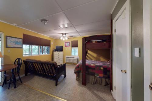 a bedroom with a bunk bed and a table at Acapulco's Hideaway in Lake Murray Shores