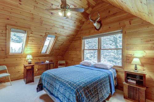 a bedroom with a bed in a wooden cabin at River Ridge Rendezvous in Morrisville