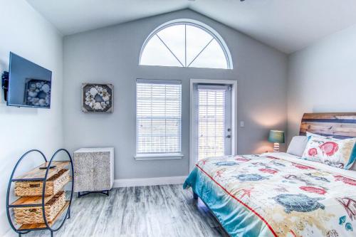 a bedroom with a bed and a window at Pathway 14820 in Padre Island