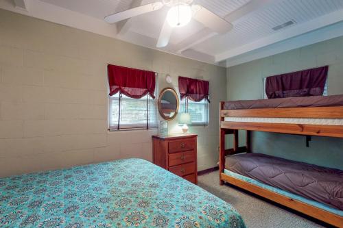 a bedroom with two bunk beds and a mirror at Captain's Cove in Lake Murray Shores