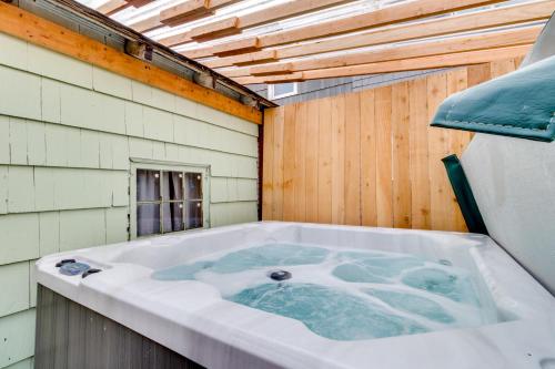 a jacuzzi tub in a room with a wooden wall at The River Belle in Seaside