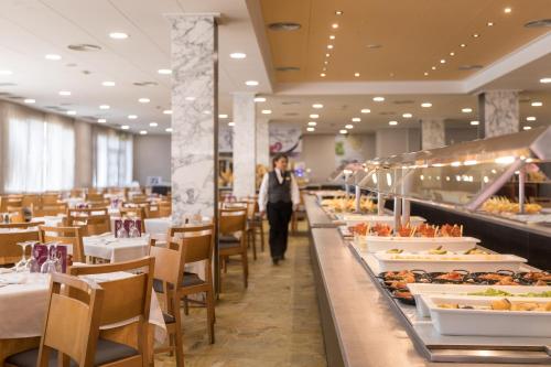 a person walking down a buffet line in a restaurant at htop Olympic #htopEnjoy in Calella