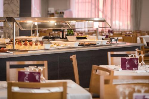 a restaurant with a buffet of food on a table at htop Olympic #htopEnjoy in Calella