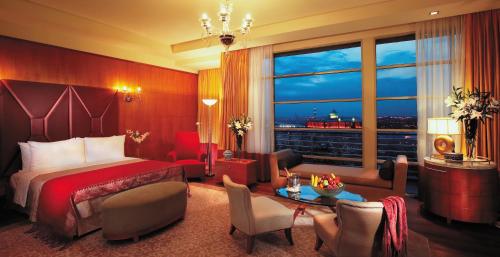 a hotel room with a bed and a large window at PULSE GRANDE Hotel Putrajaya in Putrajaya