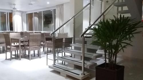 a staircase in a room with a table and a potted plant at Pousada Ilha das Conchas in Guarujá