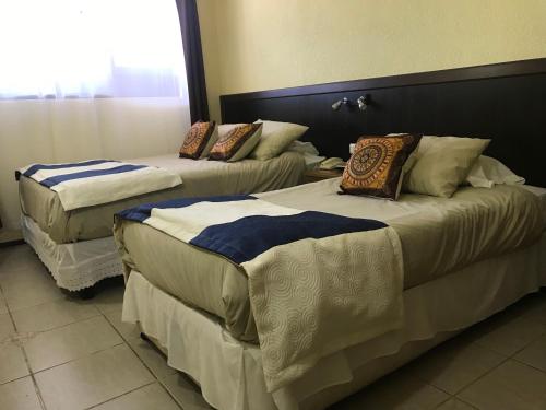 Katil atau katil-katil dalam bilik di Inti Hotel
