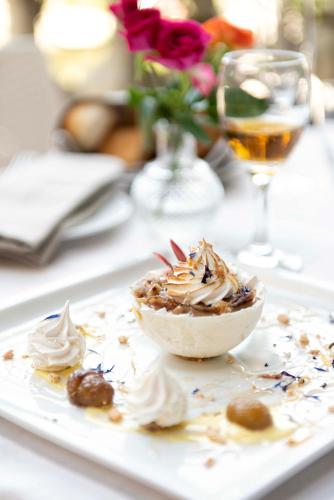 a white plate with a bowl of food on a table at Hotel Terme di Stigliano in Canale Monterano