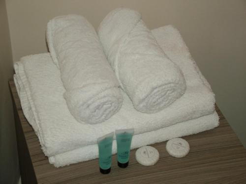 a stack of towels sitting on top of a table at Thistle Cottage in Mildenhall