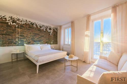 a bedroom with a bed and a couch at Il Sogno di Manarola by The First in Manarola