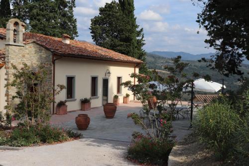 a building with a patio in front of it at Borgo di Villa Cellaia Resort & SPA in Dicomano