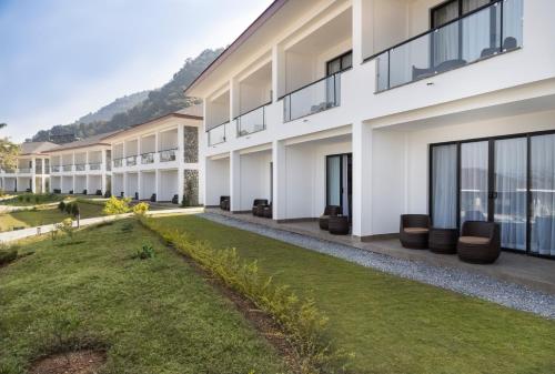 an exterior view of a building with a yard at Mountain Glory Forest Resort in Pokhara