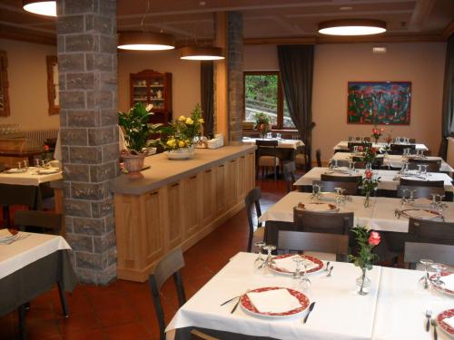 a dining room with tables and chairs in a restaurant at Hotel Bristol in Fiumalbo