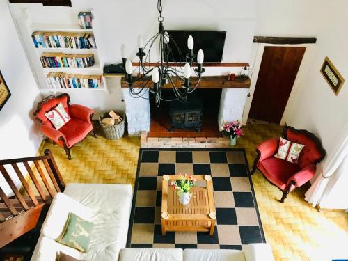 a living room with a table and a fireplace at La Blatière French Cottages in La Chapelle-Saint-Étienne