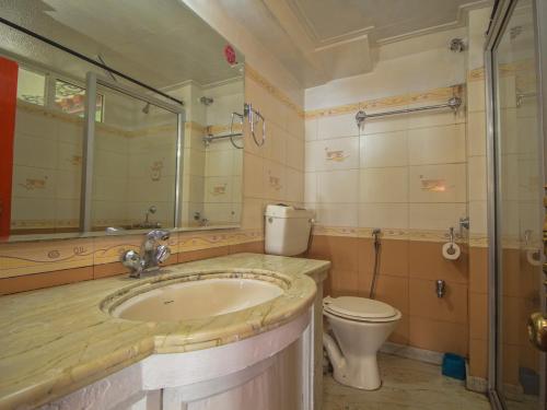 a bathroom with a sink and a toilet at hotel Seven Seventeen in Darjeeling