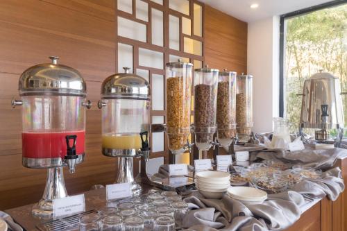 a table with some food in glass containers on it at Mountain Glory Forest Resort in Pokhara