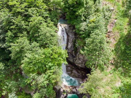 an aerial view of a waterfall in a forest at Pension Bellevue Gondo in Ruden