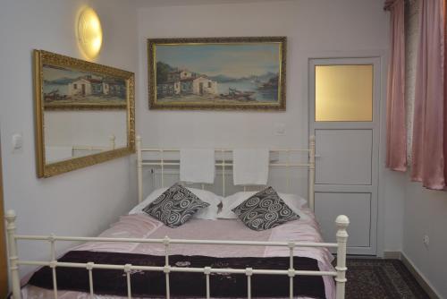 a bedroom with a bed with two pictures on the wall at Piaseczno Willa Staropolska in Piaseczno