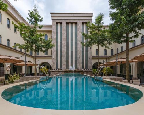 a swimming pool in front of a building at Radisson Lagos Ikeja in Lagos