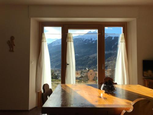 a dining room table with a view of a mountain at Residenza Sertorelli in Bormio
