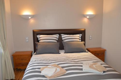 a bedroom with a bed with two towels on it at le domaine du chaffard in Les Avenières