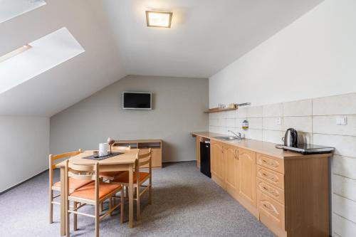 a kitchen with a table and chairs in a room at Pivovar a Penzion GRASEL in Český Rudolec