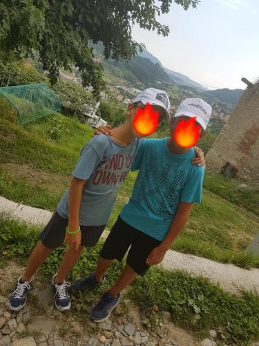 two young men standing next to each other with orange lights at Amata Valgre Affittacamere, comfort e pulizia eccezionali!! in Olginate