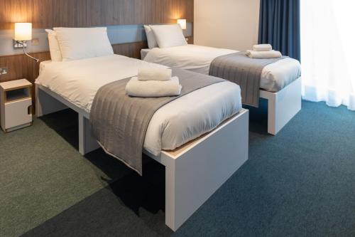 Säng eller sängar i ett rum på Elite Athlete Centre and Hotel