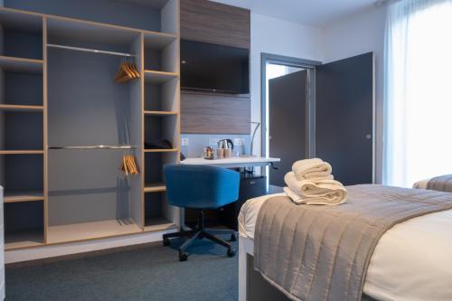 a bedroom with a bed and a desk and a chair at Elite Athlete Centre and Hotel in Loughborough