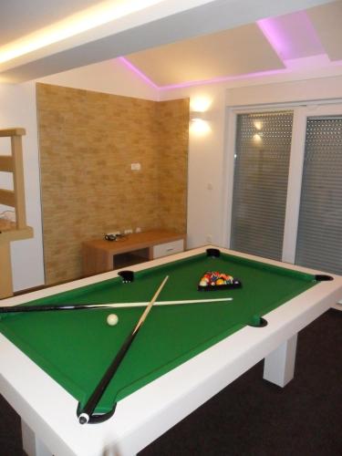 a pool table in a living room with at Luxury Villa Star Lights Trogir - heated pool, hot tub, gym, billiard in Trogir