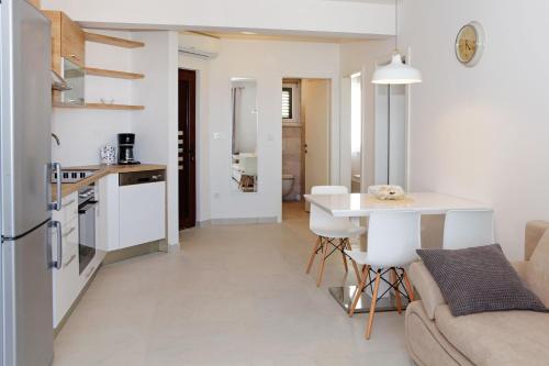a kitchen and living room with a couch and a table at Apartments Lena in Bol