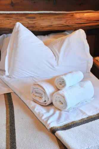 a bed with towels and pillows on it at Affittacamere De Charme Jour Et Nuit in Torgnon