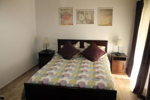 a bedroom with a bed with two tables and two lamps at La Posada de Mijas in Mijas