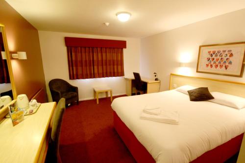 a hotel room with a bed and a desk at Days Inn Hotel Gretna Green in Gretna Green