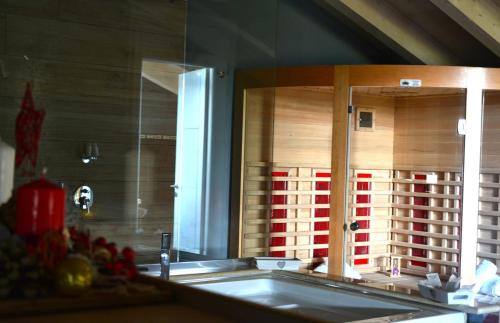 a mirror over a sink in a kitchen at B & B Le due noci in Grottaminarda