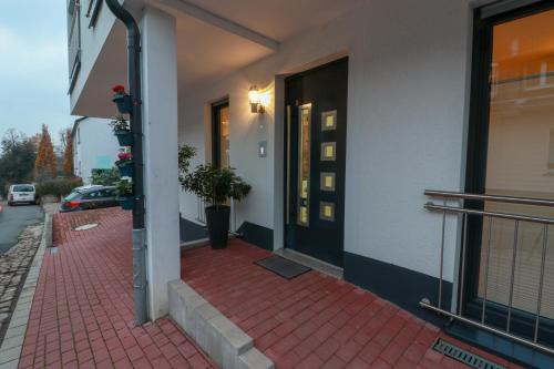 a building with a red brick sidewalk next to a door at Haus Sonnenschein in Witten