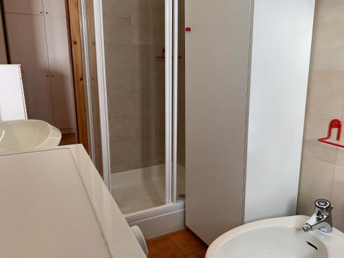 a bathroom with a shower and a toilet and a sink at Trentino Apartments - Casa Aurora in Folgaria