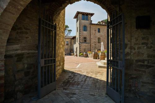 an archway in a building with an open door at Castel Monastero - The Leading Hotels of the World in Castelnuovo Berardenga