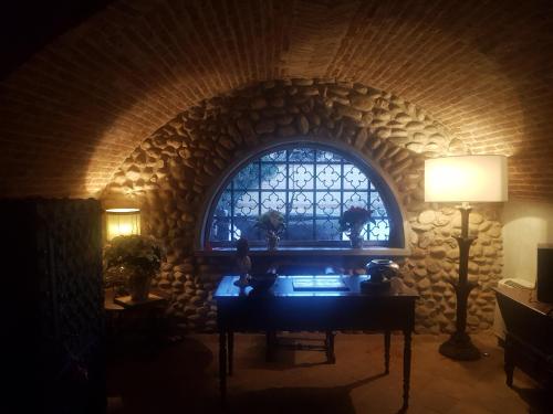 a room with a window and a table with a lamp at ANTICA VILLA CUNEO- Guest House - "B&B e non un Hotel a Cuneo" in Cuneo