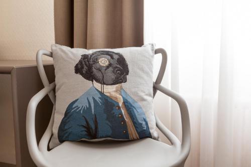 a pillow with a picture of a black dog at Hotel Le Sevigne - Sure Hotel Collection by Best Western in Rennes