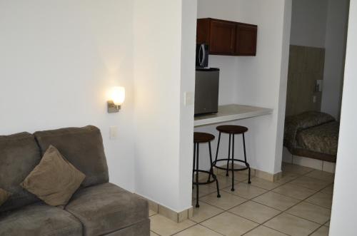 a living room with a couch and a kitchen at Eco Bay Hotel in Bahía Kino
