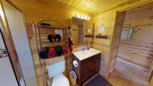 drewniana łazienka z toaletą i umywalką w obiekcie White Pine Cabin by Canyonlands Lodging w mieście Monticello
