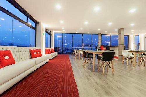 a living room with a white couch and a table at Hotel Max in Pasto