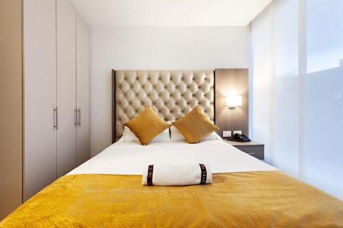 a bedroom with a large bed with a large headboard at Hotel Max in Pasto